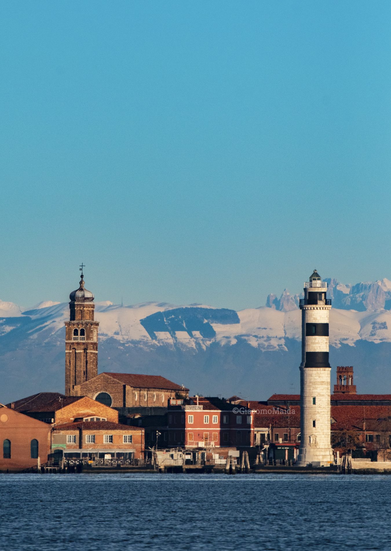 Venice Lagoon and Murano Island with Dolomites in the background. View from vaporetto.